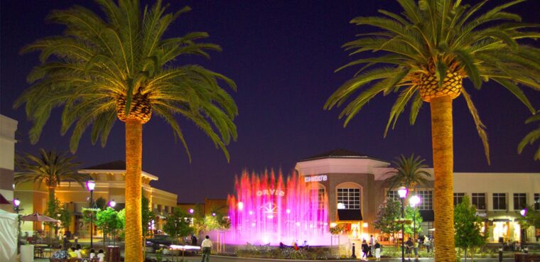 palm trees surrounding fountain at shopping center