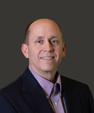 A headshot of Dennis Thompson