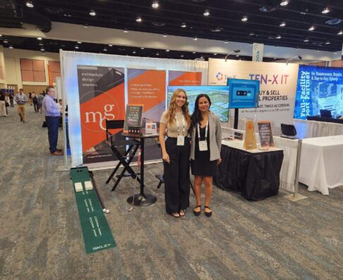 two mcg employees at a marketing booth