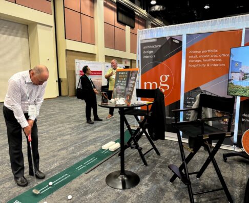 an mcg employee hitting a golf ball