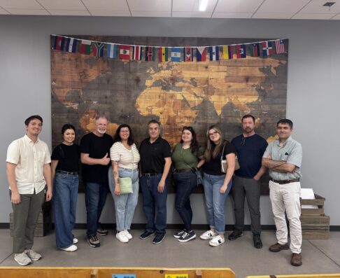 mcg employees standing in front of a map