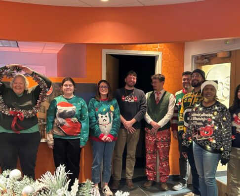mcg employees dressed in holiday sweater