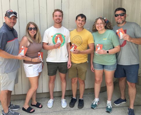 mcg employees holding party hats