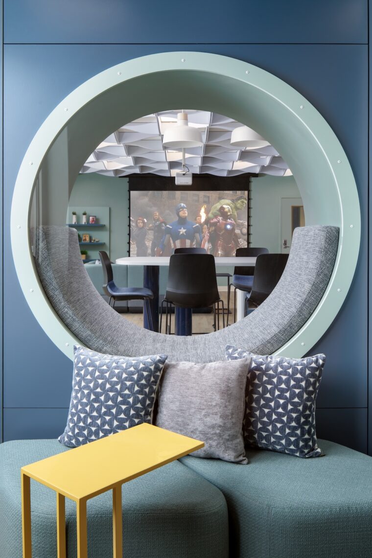 A couch below a mirror at the Teen Loune