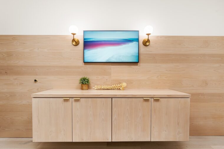 A tv above at cabinet at The Orchard Spinal Clinic